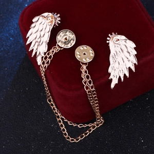 Golden wing collar pins with double chains on a luxury velvet jewelry gift box