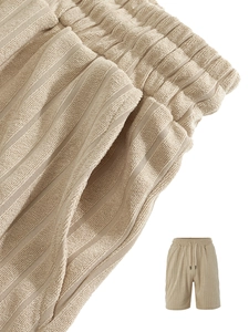 Detail of men's casual shorts showing waffle textured fabric and drawstring elastic waist