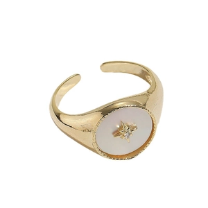 Vintage golden open ring with shell inlay and sparkling star detail on white background