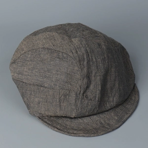Macro shot of dark taupe linen baseball cap showing detailed cotton-linen blend fabric texture