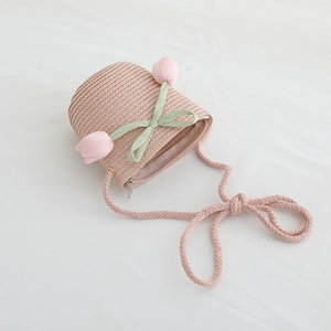 Detail of pink straw crossbody bag for girls featuring tulip flowers and bow accent