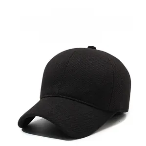 Detailed close-up of thick woolen baseball cap fabric with a side metal K-logo accent