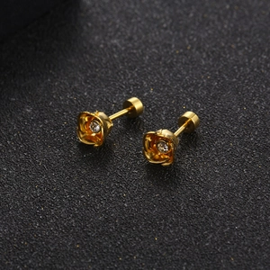 Exquisite gold-plated rose stud earrings with sparkling center crystals on black background