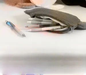 Detailed view of grey plush teddy bear makeup bag showing large storage capacity for pens