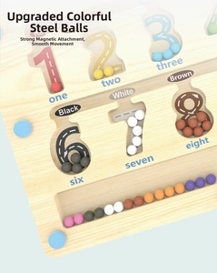 Detail of wooden magnetic maze board showing color sorting beads and numeric paths