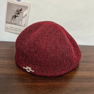 Women's burgundy knit beret hat with red sequins and rhinestone bow decoration