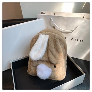 Detailed view of the khaki faux fur rabbit ear backpack presented in a premium gift box