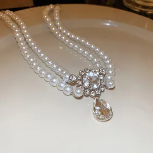 Double-layered pearl necklace with rhinestone water-drop pendant in elegant French style