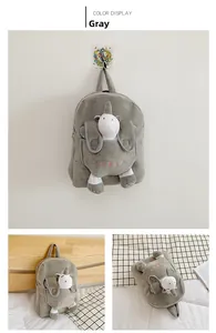 Detailed view of gray plush children's backpack with unicorn doll and HSLP embroidery