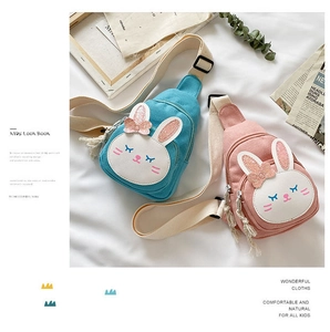 Close-up of kids cute bunny chest bags in pink and blue with sequin bow details