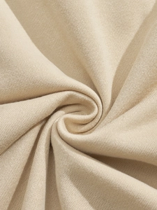 Macro shot of high-density beige corduroy fabric texture with artistic spiral folds