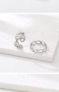 Detailed shot of silver adjustable H-link anchor chain rings on white stone stand