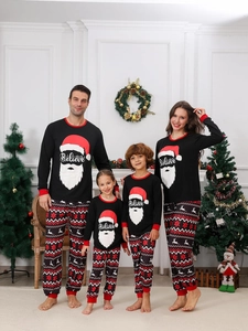 Close-up of Christmas pajamas set with Santa print and Fair Isle patterned trousers