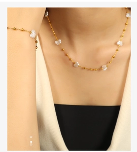 Elegant 18k gold plated necklace and bracelet set with irregular white pearls on a model