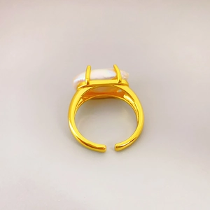 Vintage style gold open ring featuring a large irregular natural baroque pearl center