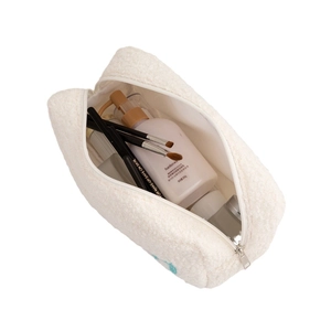 White plush makeup bag with large capacity and zipper closure for travel storage