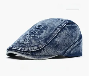 Detail of distressed dark blue denim flat cap with vintage worn-out hole design