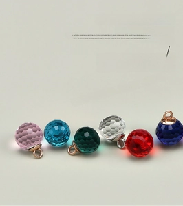 Detailed close-up of 10mm faceted glass bead buttons in vibrant multiple colors with metal loops