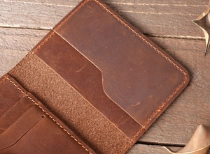 Detail view of crazy horse leather card holder featuring vintage texture and hand stitching
