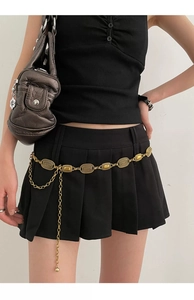 Detail of vintage gold metal waist chain with textured oval links and hanging chain