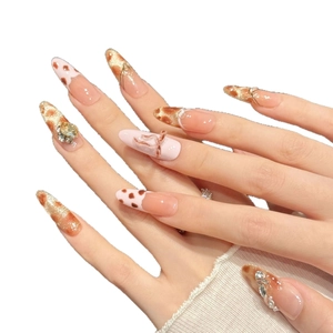 Pink leopard print press-on nails with 3D metal bows and rhinestones on long stiletto shape