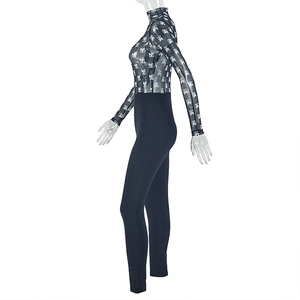 Detail of sheer black mesh bodysuit with monogram print and long sleeves