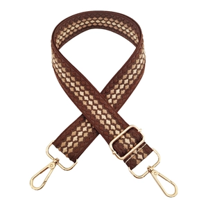 Close-up of thick adjustable nylon handbag strap with coffee diamond weave and gold hooks