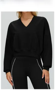 Detail of premium black V-neck cropped hoodie with front pocket and side striped leggings