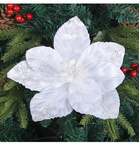 Close-up of white sequined Christmas poinsettia flower with silver glitter details