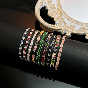 Close-up of assorted colorful gemstone tennis bracelets on a luxury jewelry display stand