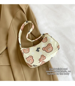 Detail shot of bear pattern on shoulder bag fabric with cute bow and polka dots