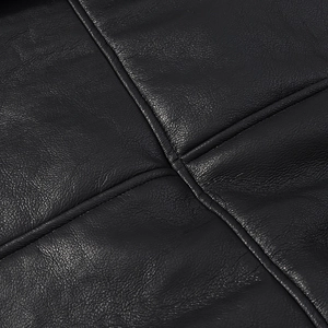 Close-up of black faux leather jacket texture with high-quality cross stitching details