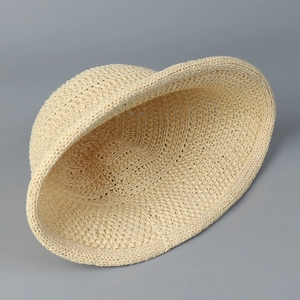 Top view showing internal crochet weave structure of the beige knit bucket hat