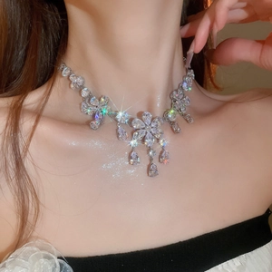 Close-up of sparkling floral pendant necklace with crystal teardrops and starburst effect