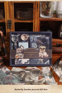 Detail of vintage butterfly journal kit with stickers and washi tapes in dark blue box