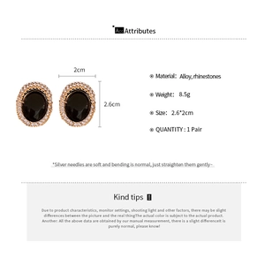 Detailed view of vintage oval stud earrings with black stones and rhinestone accents