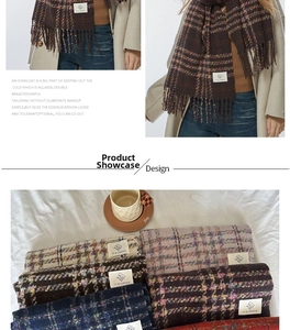 Detail of plaid tassel scarf showing warm brown tones and soft cashmere-like texture