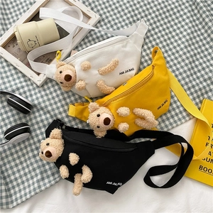 Canvas crossbody bag with cute teddy bear accessory in white, yellow, and black colors