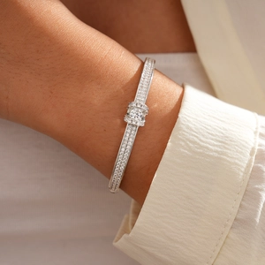 Macro detail of silver tone oval buckle bracelet with pave-set shimmering zircon stones