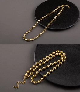 Detail of 18K gold-plated stainless steel ball bead necklace with adjustable lobster clasp