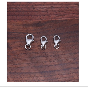 Macro detail of three S925 sterling silver lobster clasps for DIY jewelry making