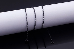 Detail of black stainless steel cross chain with lobster clasp and extender link