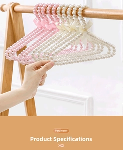 Close-up of pearl hangers with elegant silk bows in pink and cream white colors