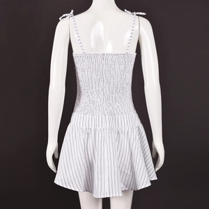 Detail view of the back of a black and white striped mini dress with lace-up straps