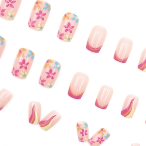 Short square press-on nails featuring colorful floral patterns and wavy French designs