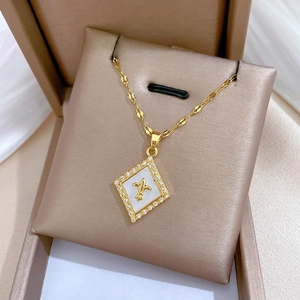 Elegant gold titanium steel necklace featuring a diamond-set rhomboid shell flower pendant