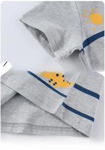 Macro detail of high-quality stitching on the cuff and hem of boys' dinosaur t-shirt