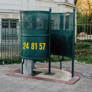 Detail showing high-visibility 4 inch yellow number stickers on dark green metal surface