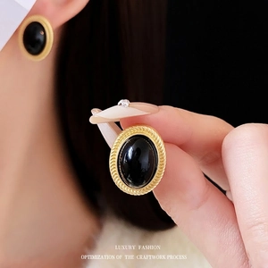 Vintage oval black stone stud earrings with golden textured braided frame for women