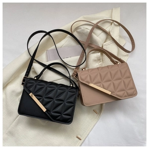 Top view of two quilted PU leather handbags in black and beige with metal buckle accents